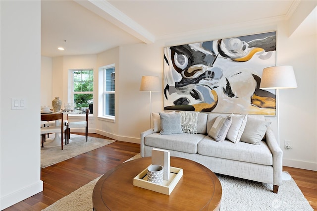 living area featuring beamed ceiling, baseboards, and wood finished floors