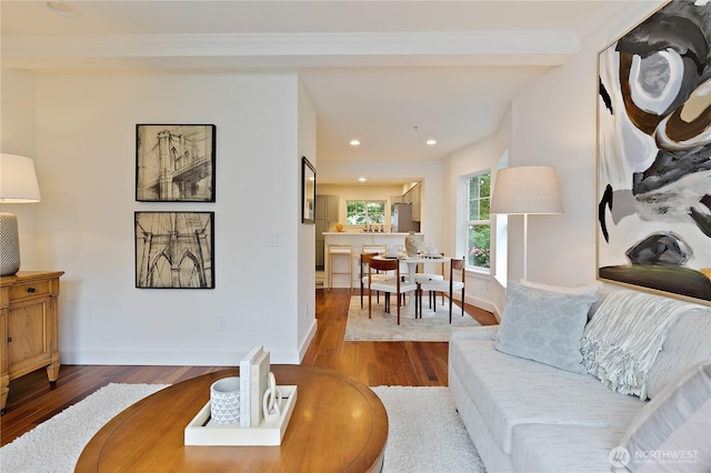 living room with baseboards, wood finished floors, and recessed lighting