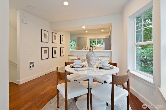 dining area with recessed lighting, baseboards, and wood finished floors