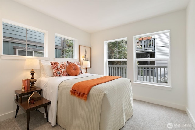 carpeted bedroom featuring baseboards