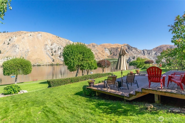 view of yard featuring a deck with mountain view