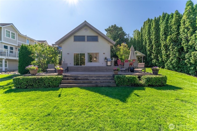 back of house with a lawn and a wooden deck