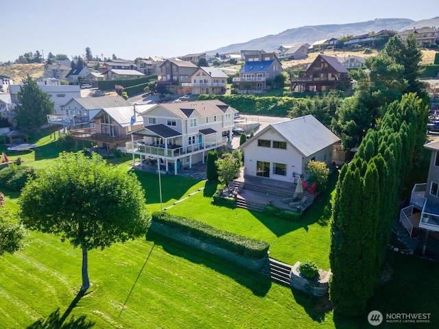 drone / aerial view featuring a residential view and a mountain view