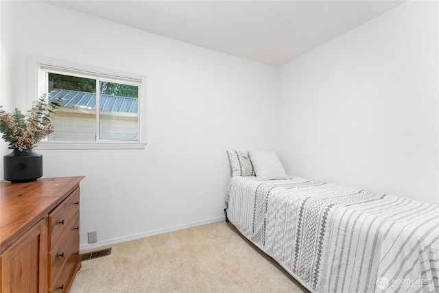 bedroom featuring light carpet, baseboards, and visible vents