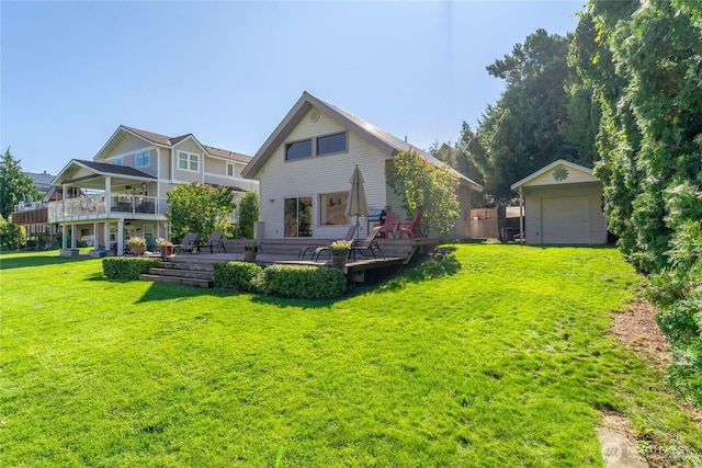 rear view of property with a lawn and an outdoor structure