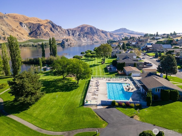 exterior space with a water and mountain view