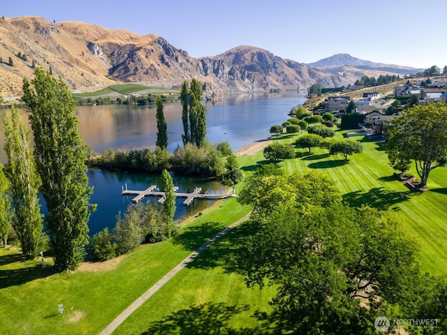 birds eye view of property with a water and mountain view