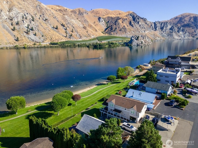 drone / aerial view featuring a water and mountain view