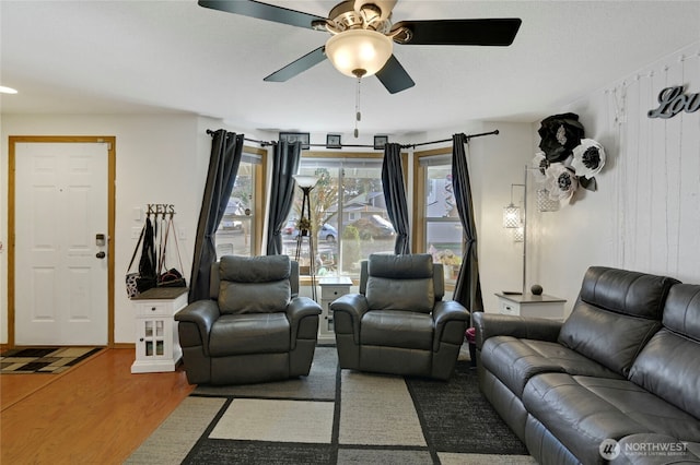 living room featuring ceiling fan and wood finished floors