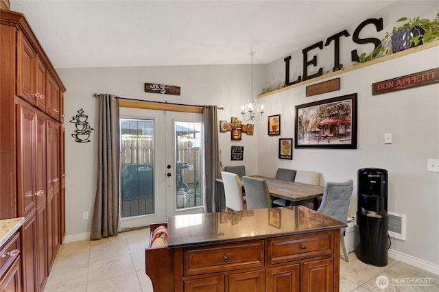 office space with french doors, lofted ceiling, visible vents, an inviting chandelier, and baseboards