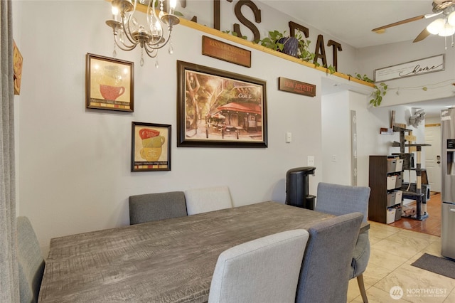 dining area with ceiling fan with notable chandelier and light tile patterned flooring