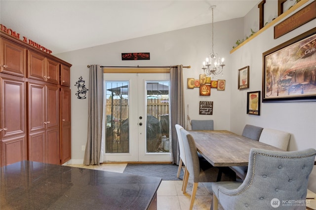 dining room featuring lofted ceiling, french doors, light tile patterned flooring, and a notable chandelier