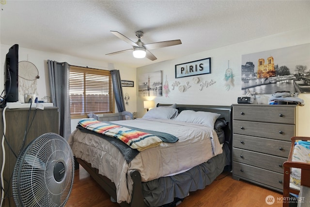 bedroom featuring ceiling fan, a textured ceiling, and wood finished floors