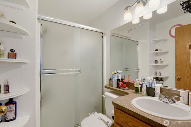 full bathroom featuring a stall shower, vanity, and toilet