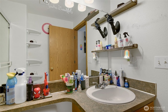 bathroom featuring double vanity and a sink