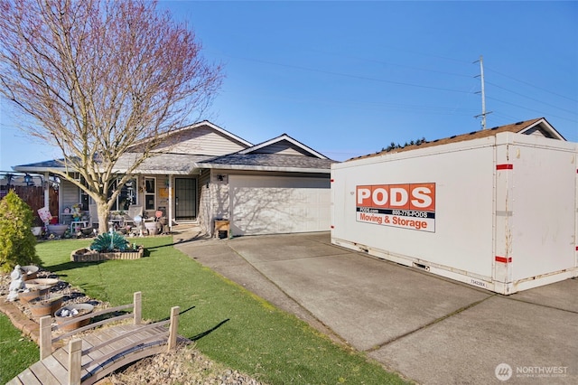 view of front of home with a garage, concrete driveway, and a front lawn