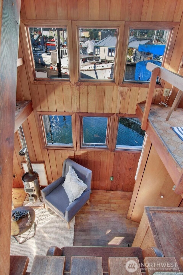 living area featuring wood finished floors and wooden walls