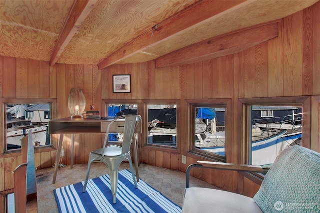 office area with beamed ceiling and wooden walls