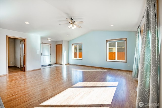 unfurnished room with wood finished floors, a ceiling fan, baseboards, recessed lighting, and vaulted ceiling