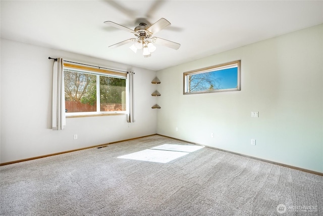 spare room featuring visible vents, baseboards, carpet, and ceiling fan