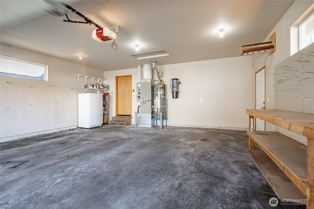 garage with water heater, a workshop area, and a garage door opener