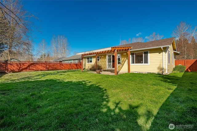 rear view of property featuring a yard, a patio area, a fenced backyard, and a pergola