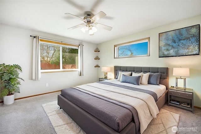 bedroom with a ceiling fan, baseboards, and carpet floors