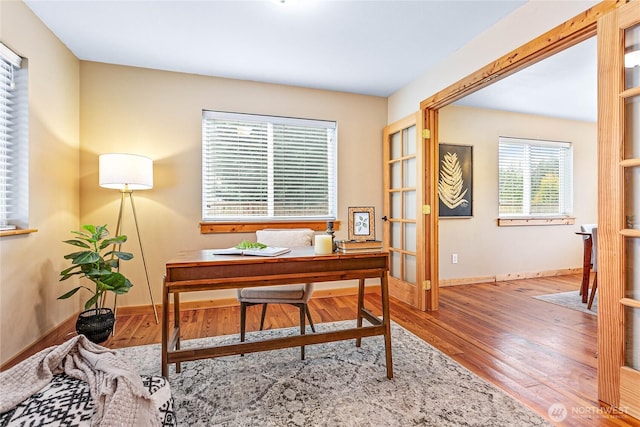 home office featuring baseboards and wood finished floors