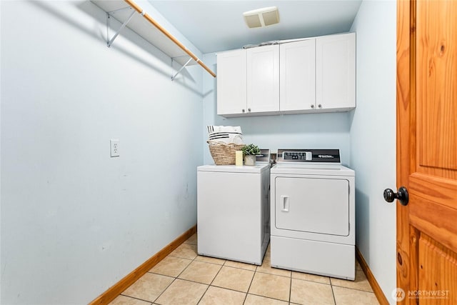 laundry area with light tile patterned floors, visible vents, baseboards, cabinet space, and independent washer and dryer