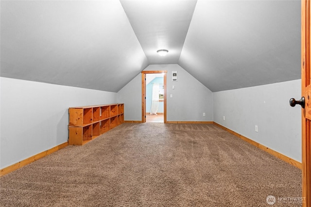 bonus room with baseboards, carpet floors, and vaulted ceiling