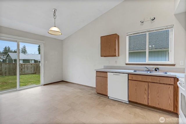 kitchen with lofted ceiling, light countertops, white dishwasher, and a sink