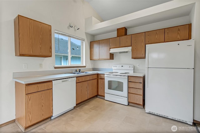 kitchen featuring lofted ceiling, light countertops, a sink, white appliances, and under cabinet range hood