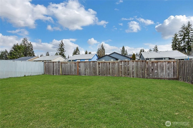 view of yard with a residential view and a fenced backyard