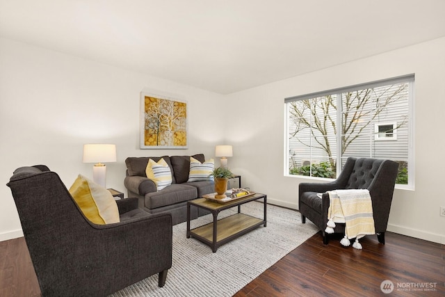 living area featuring baseboards and wood finished floors