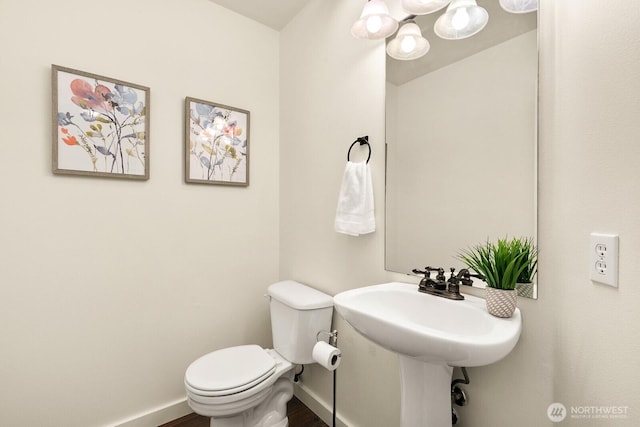 half bath with toilet and baseboards