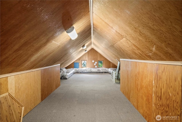 bonus room with lofted ceiling, wood ceiling, and wood walls