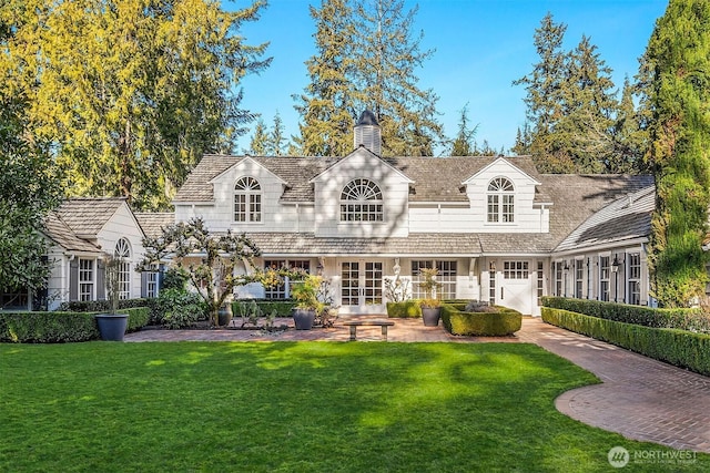 rear view of property with a lawn and a chimney