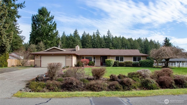 ranch-style house featuring a garage, concrete driveway, a chimney, fence, and a front yard