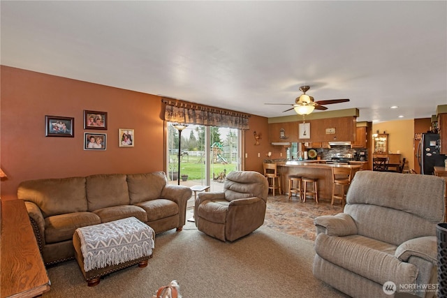 carpeted living area featuring a ceiling fan and recessed lighting