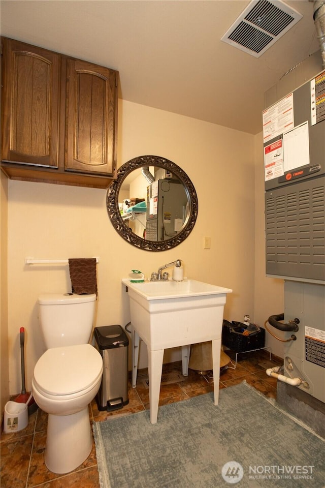 half bath featuring visible vents and toilet