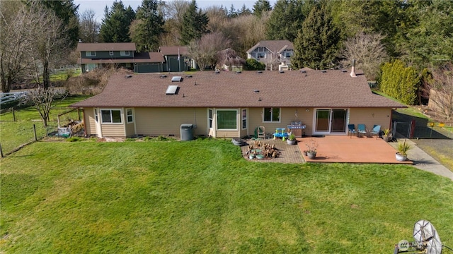 rear view of property featuring a patio area, a fenced backyard, and a yard