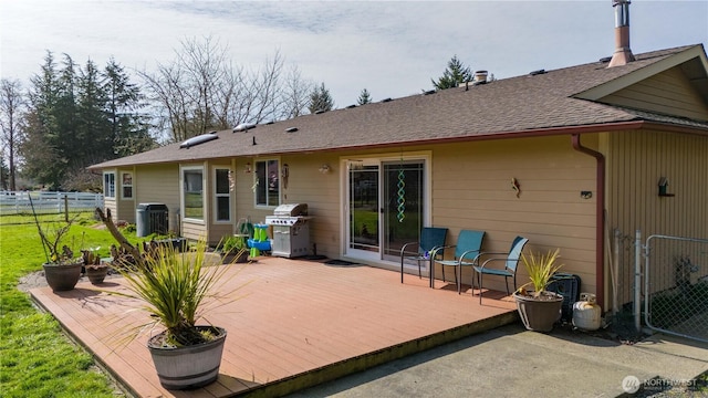 back of house featuring central air condition unit, a shingled roof, fence, and a wooden deck