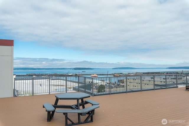 wooden deck featuring a water view