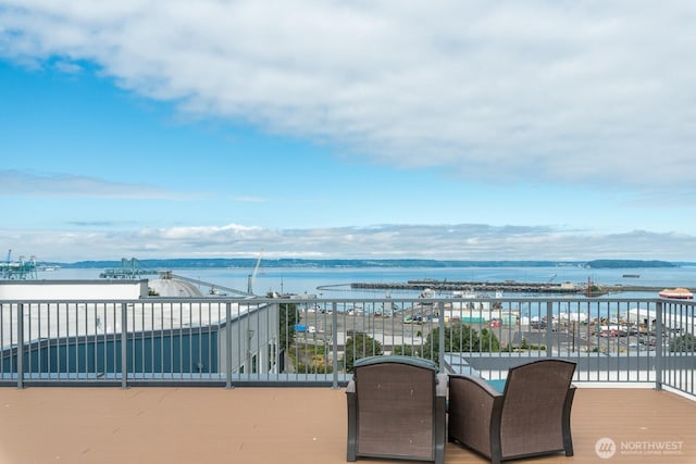 view of patio / terrace with a balcony and a water view