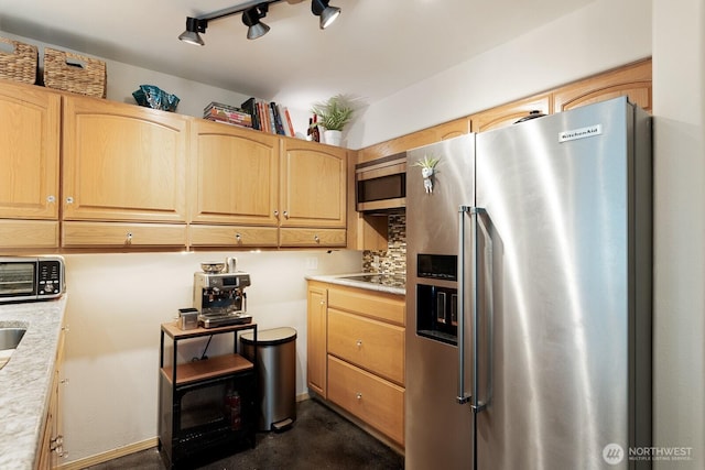 kitchen with light brown cabinets, appliances with stainless steel finishes, and light countertops