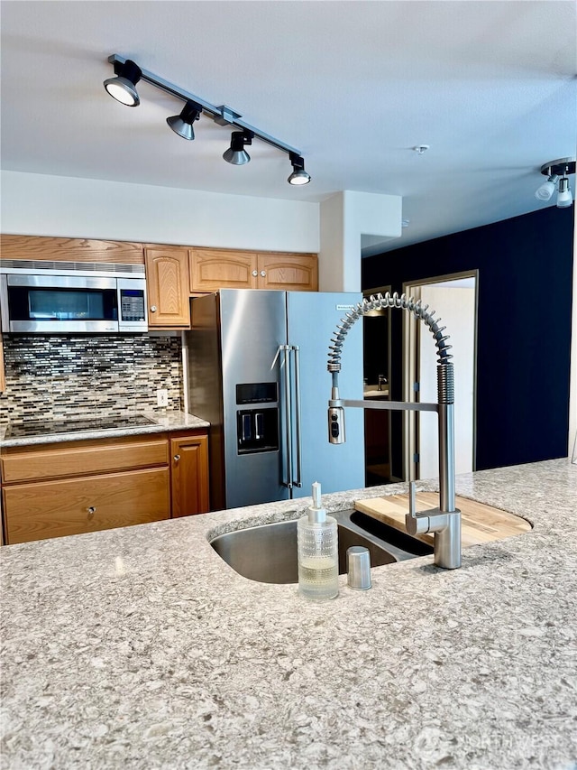 2824 Grand Ave Unit A212, Everett, WA 98201 - kitchen with stainless steel appliances, tasteful backsplash, light stone counters, and a sink