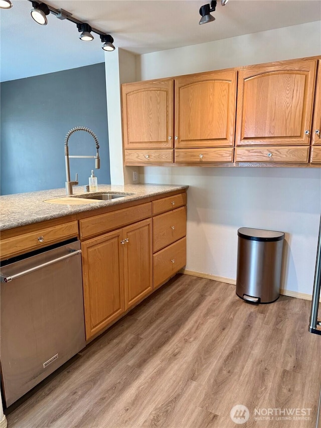 2824 Grand Ave Unit A212, Everett, WA 98201 - kitchen featuring a sink, stainless steel dishwasher, light wood-style flooring, and baseboards