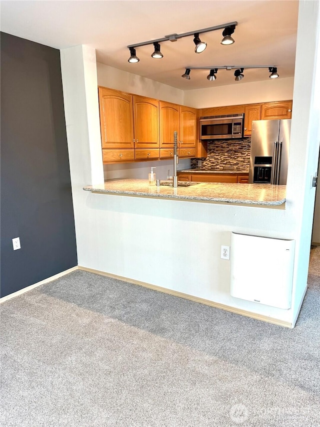 2824 Grand Ave Unit A212, Everett, WA 98201 - kitchen with appliances with stainless steel finishes, a sink, carpet, and decorative backsplash