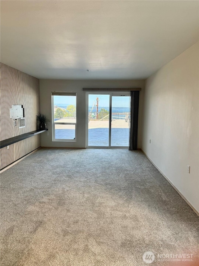 2824 Grand Ave Unit A212, Everett, WA 98201 - unfurnished living room featuring carpet flooring and baseboards