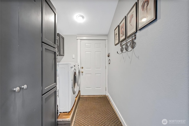 laundry room with cabinet space, washer and clothes dryer, and baseboards